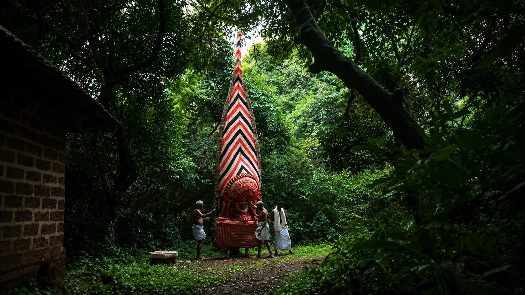 A Theyyam ritual performance in the forest near Othayoth Villa, Kannur, Kerala
